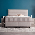 SUNA Boxspringbett in Webstoff Grau, Frontansicht mit gepolstertem Kopfteil, Matratze und Topper im Schlafzimmer