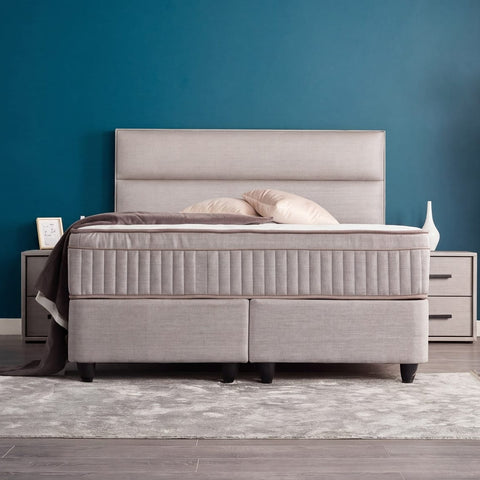 SUNA Boxspringbett in Webstoff Grau, Frontansicht mit gepolstertem Kopfteil, Matratze und Topper im Schlafzimmer