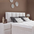 Detail vom gepolsterten Kopfteil des Lucas Boxspringbetts in Creme mit Stoffbezug, Kissen und Matratze