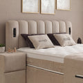 Wind Boxspringbett Detail vom gepolsterten Kopfteil aus Stoff in Beige mit Wind-Kissen und Nachttisch
