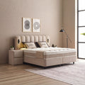 Wind Boxspringbett in Beige, seitliche Ansicht mit Stoffbezug, Kopfteil und Nachttisch im hellen Schlafzimmer